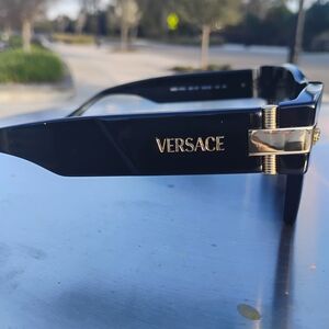 Versace Black Sunglasses with Gold Accents.